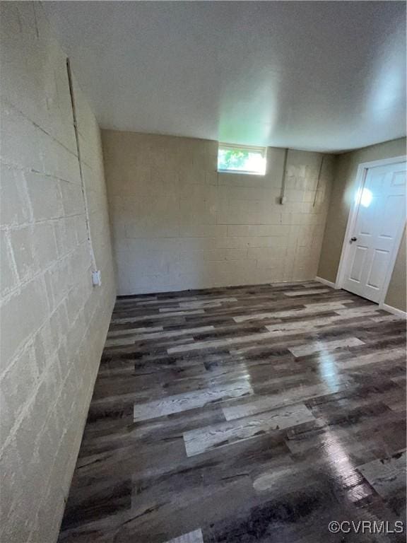 basement with dark hardwood / wood-style flooring