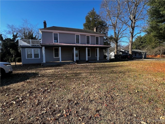 front of property with a front yard and covered porch