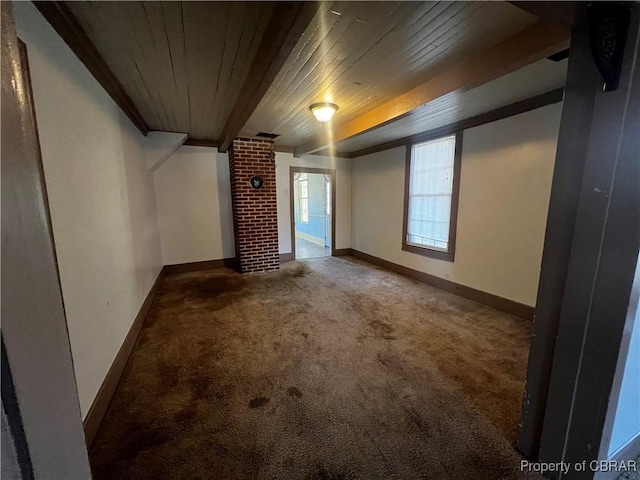 interior space featuring carpet flooring, wood ceiling, and beamed ceiling