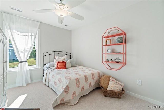 bedroom with ceiling fan and light colored carpet