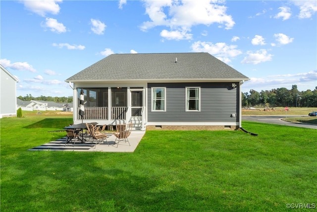 back of house with a yard, a patio area, and a sunroom