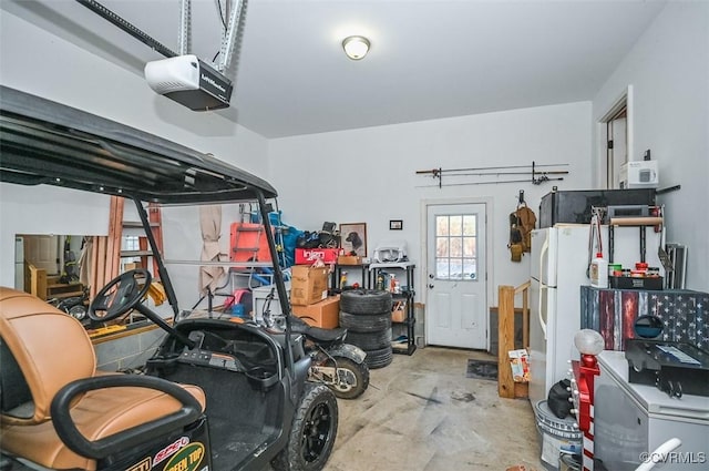 garage with white refrigerator and a garage door opener