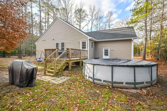 rear view of property featuring a deck