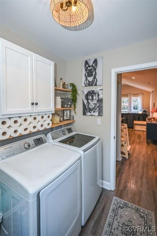 clothes washing area featuring cabinets, separate washer and dryer, and dark wood-type flooring