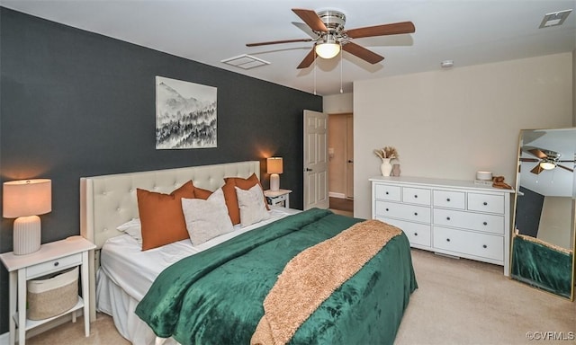 bedroom with ceiling fan and light colored carpet