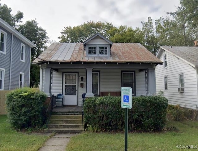 view of front facade featuring covered porch and a front yard