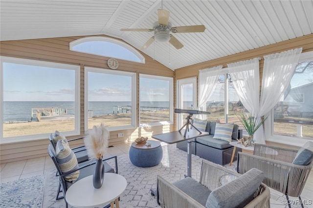 sunroom with ceiling fan, a water view, and vaulted ceiling