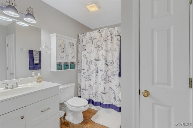 bathroom featuring toilet, vanity, and walk in shower