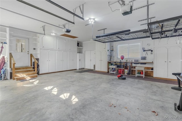 garage with a workshop area and a garage door opener