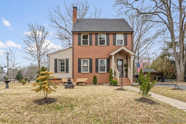 colonial inspired home with a front lawn