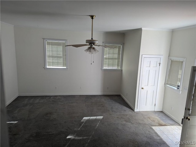 carpeted spare room featuring ornamental molding and ceiling fan