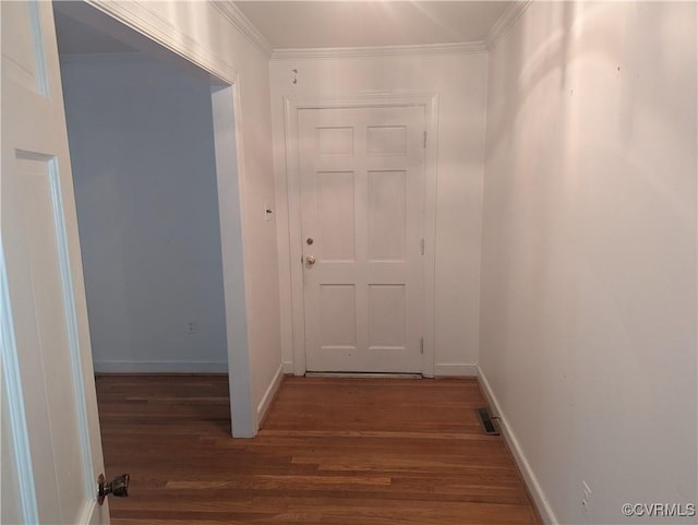 hallway with dark hardwood / wood-style flooring and ornamental molding