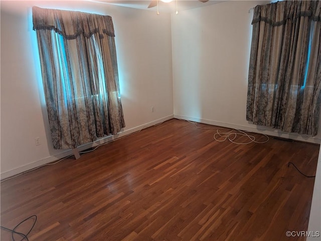 spare room featuring wood-type flooring and ceiling fan