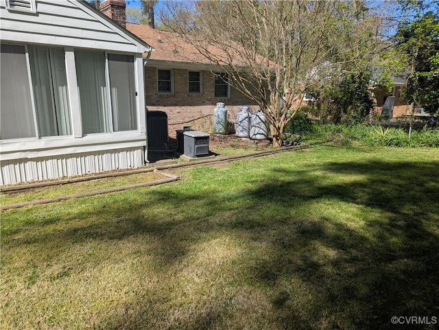 view of yard featuring central air condition unit