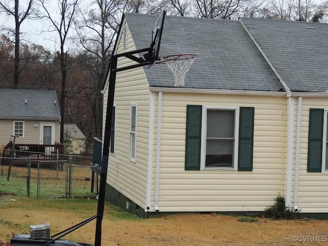 view of property exterior with basketball court