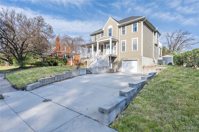 view of front of property with covered porch, a garage, a front yard, and central AC