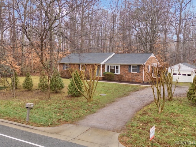 single story home featuring an outbuilding and a front yard