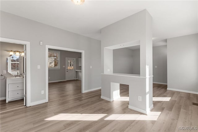 unfurnished living room with light wood-type flooring