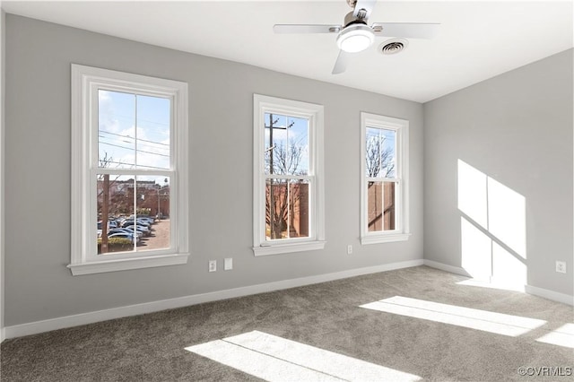 empty room featuring carpet floors and ceiling fan