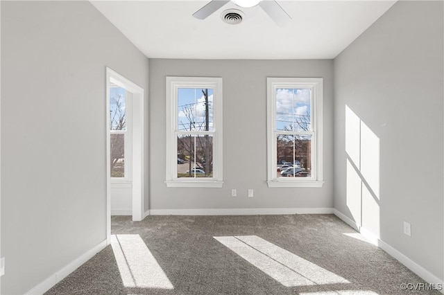 carpeted spare room with ceiling fan