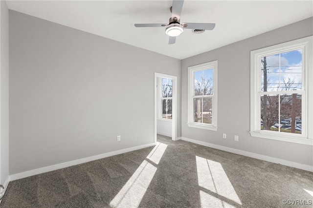 carpeted spare room featuring ceiling fan