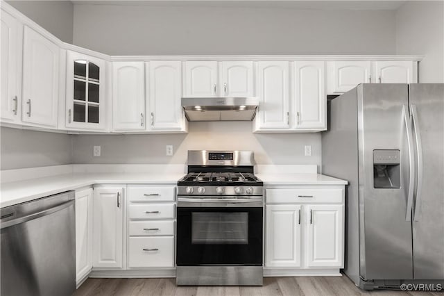 kitchen with white cabinets, appliances with stainless steel finishes, and light hardwood / wood-style floors