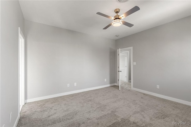 unfurnished room with light colored carpet and ceiling fan