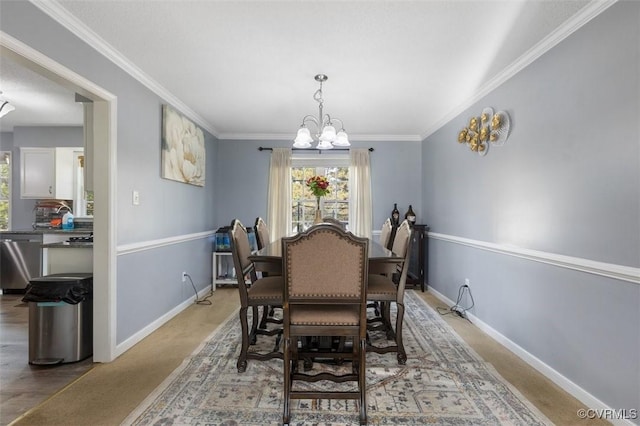 dining space with baseboards, an inviting chandelier, plenty of natural light, and ornamental molding