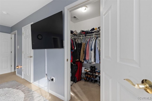 walk in closet with visible vents and carpet flooring