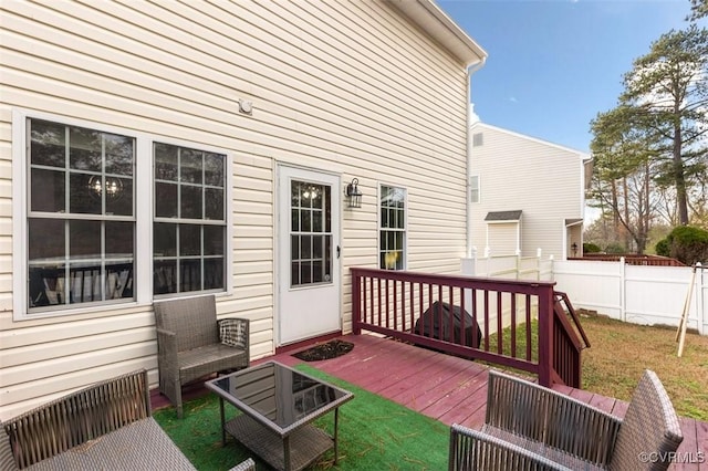 wooden deck with a yard and fence