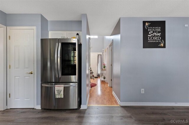 kitchen with smart refrigerator, white cabinetry, baseboards, and wood finished floors