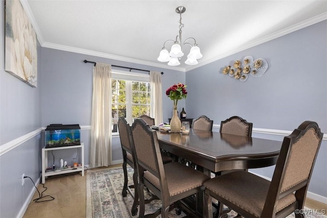 dining room with baseboards, ornamental molding, carpet, and a chandelier