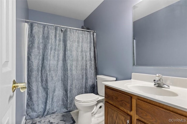 bathroom featuring toilet, tile patterned floors, curtained shower, and vanity