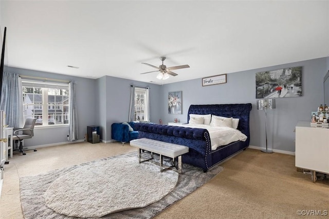 carpeted bedroom with baseboards, a ceiling fan, and visible vents