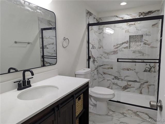 bathroom featuring toilet, an enclosed shower, and vanity