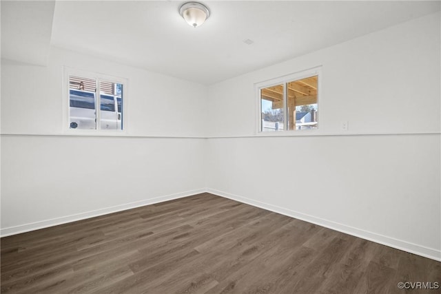 empty room with dark hardwood / wood-style floors