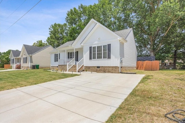 view of front of house with covered porch, fence, crawl space, a front lawn, and board and batten siding