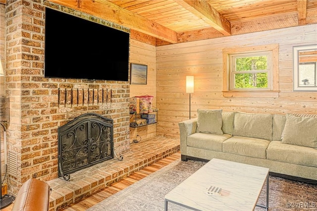 living room with a brick fireplace, wooden walls, beam ceiling, hardwood / wood-style flooring, and wooden ceiling