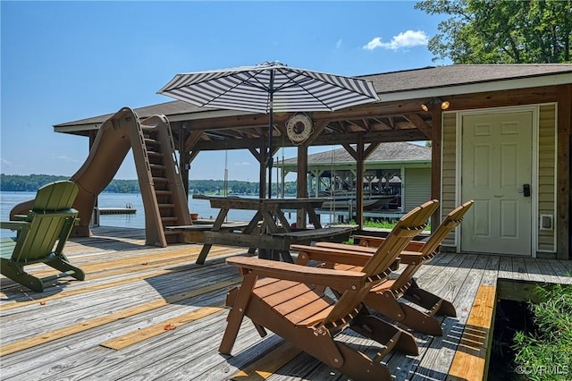 wooden deck featuring a water view