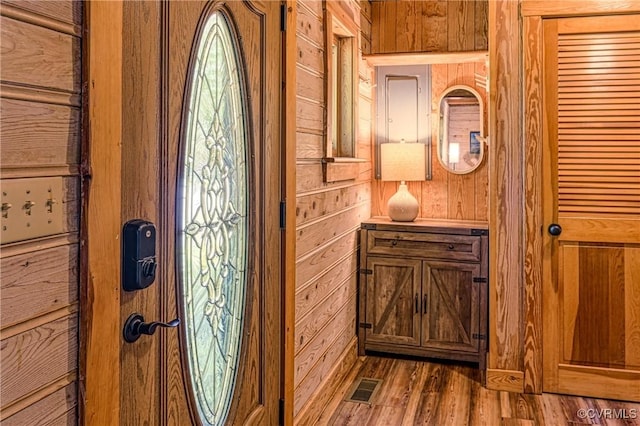 interior space featuring hardwood / wood-style flooring and wood walls