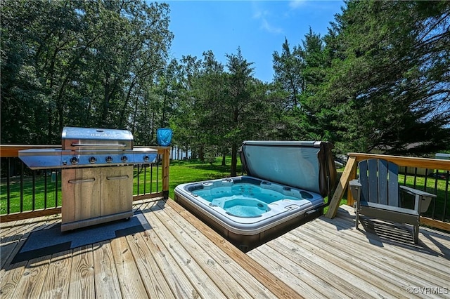 wooden deck with area for grilling, a yard, and a covered hot tub