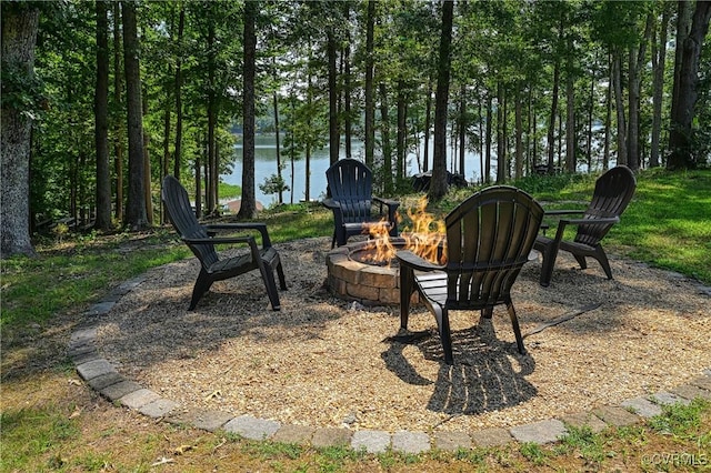 view of patio / terrace featuring a water view and a fire pit