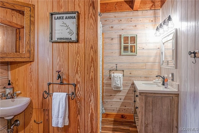 bathroom featuring double sink and wooden walls