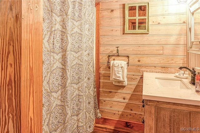 bathroom with wood walls and vanity