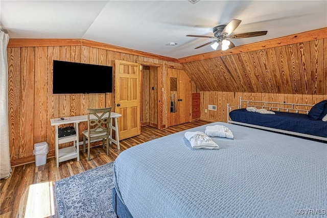 bedroom featuring dark hardwood / wood-style flooring, wooden walls, ceiling fan, and lofted ceiling