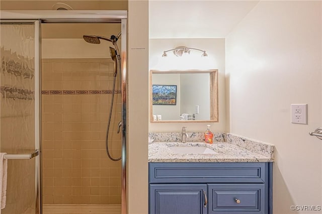 bathroom with vanity and a shower with shower door