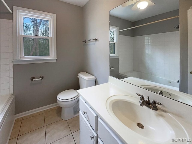 full bathroom with toilet, vanity, tile patterned floors, and a wealth of natural light