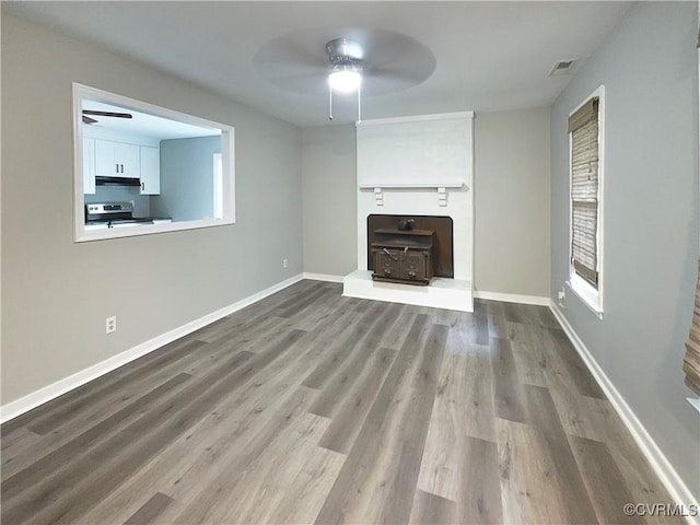 unfurnished living room with wood-type flooring and ceiling fan