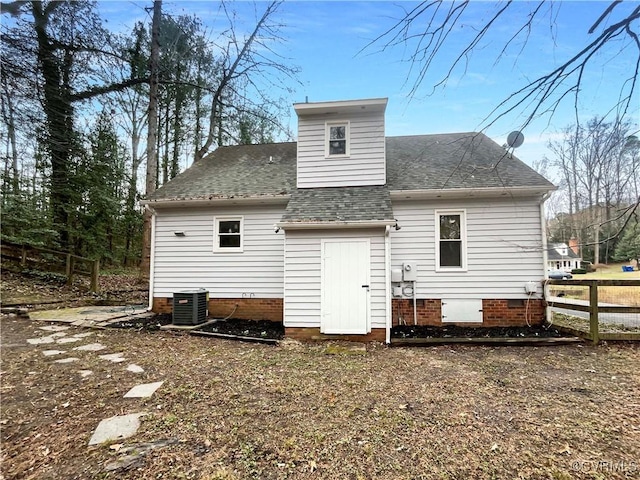 back of house with central air condition unit