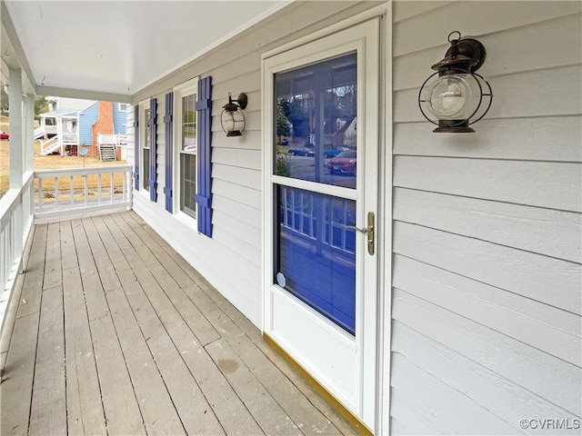 wooden terrace featuring covered porch